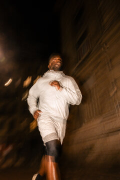 Man Jogging in the City at Night With Motion Blur Effect