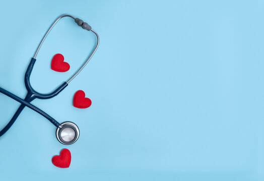 Preventive Healthcare and Health Insurance Concept with Three Red Hearts and Partially Visible Stethoscope on Blue Background Horizontal Web Banner for Medical Services and Patient Protection