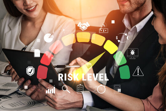 Business professionals evaluating risk levels with digital tools and graphical metrics in a modern office setting during a collaborative meeting Quark.