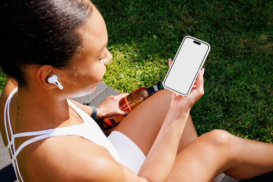 Fitness Break Woman Holding phone with White Screen. Mockup