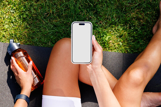 Hand Holding Phone with Blank Screen at Park. Mockup