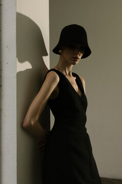 The girll standing against a wall.