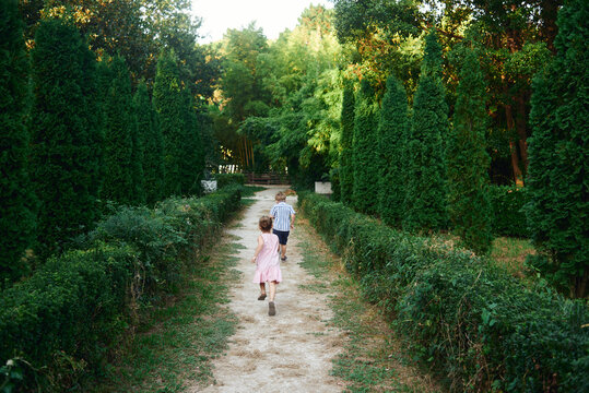 Two childs running away in the park
