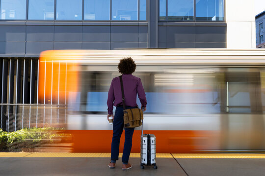 Travel man waiting on blur train blur  platform 