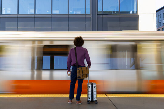 Travel man waiting on blur train platform 