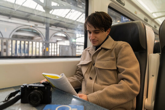 Young Student Reads Book While Commuting on the Train