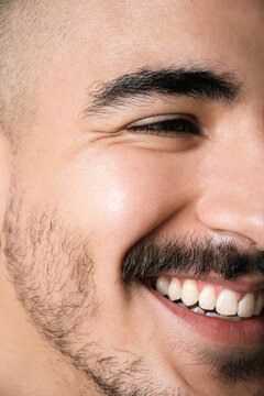 Smiling Young Man With Facial Hair Showing Joy in His Expression