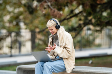 Fototapeta premium Woman making video call with laptop outdoors