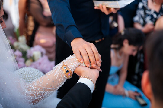 Close-Up of Hands Joined in a Wedding Blessing Ritual
