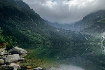 Morskie Oko lake in Tatra mountains with dramatic clouds and reflections © WellStock