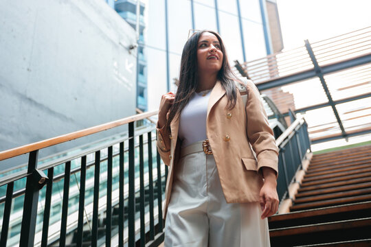 Empowered Businesswoman Walking Upstairs in the City
