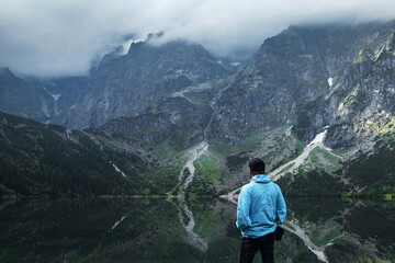 Man admiring Morskie Oko lake and Tatra mountains in spring © WellStock