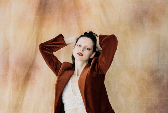 Woman in velvet jacket against warm background