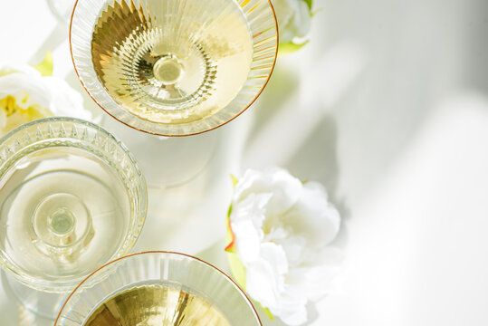 Champagne Glasses with White Peonies. Birthday or Wedding Celebration Arrangement. Top view