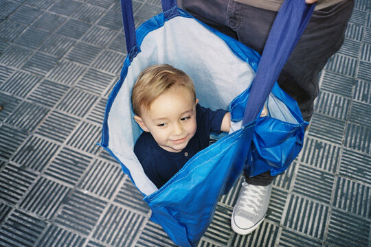 Child Playing Inside Laundry Bag