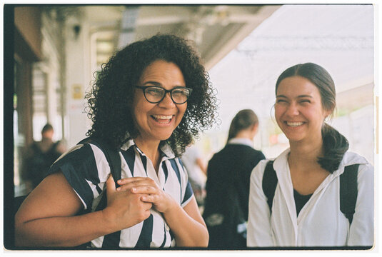 Joyful Reunion at the Train Station With Smiling Friends