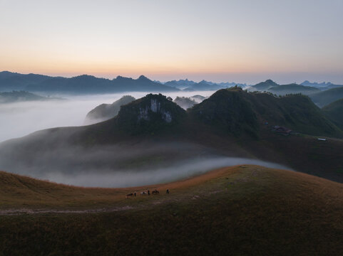 Sunrise Over Misty Hills With Horse Herders