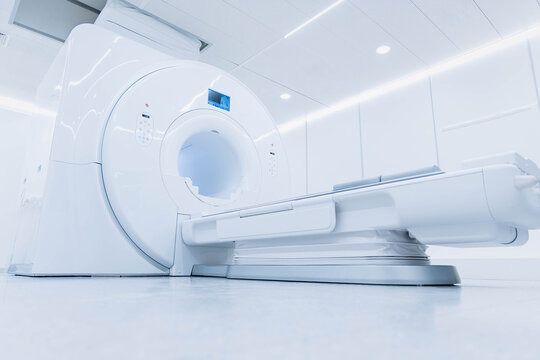 Medical CT or MRI Scan in the modern hospital laboratory. Interior of radiography department. Technologically advanced equipment in white room. Magnetic resonance diagnostics machine. Advertising