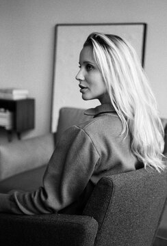 Woman sitting in a modern living room, side profile 