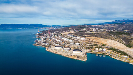 Aerial view of the INA Rijeka Refinery in Urinj, Croatia, on the Adriatic coast. Industrial complex with storage tanks by the sea.