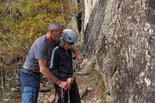 Family learning rock climbing techniques