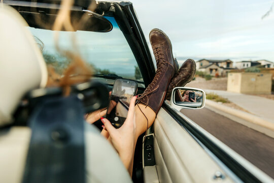 young woman on phone in convertible