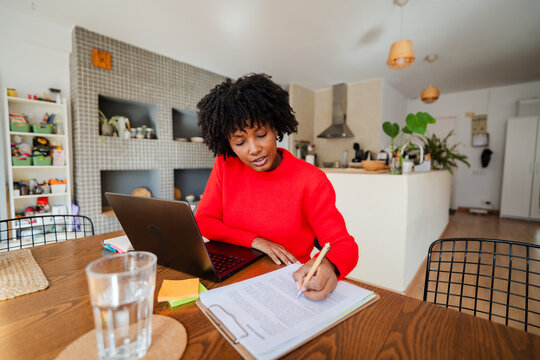 Woman diligently works from home