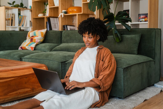 Woman uses her laptop in the living room