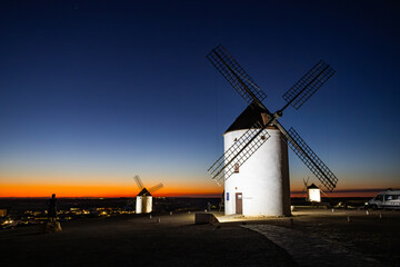Mota del Cuervo windmills glowing under sunset sky