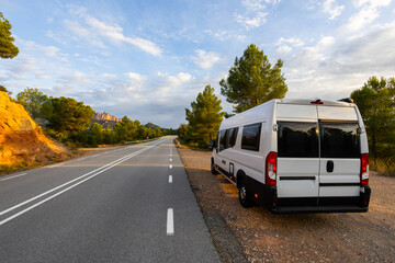 Fototapeta premium Camper van parked on road exploring Montserrat mountains