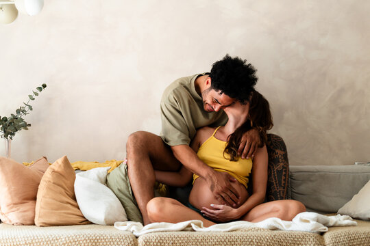Affectionate couple enjoying pregnancy process