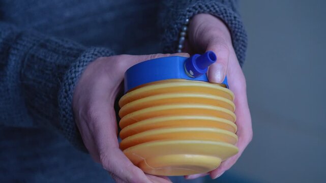 A small plastic hand pump, while inflating, creates the hissing sounds of air passing under pressure