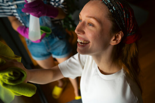 Happy woman cleaning home, enjoying household chores
