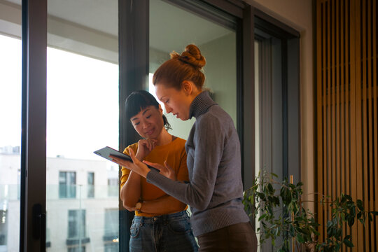 Businesswomen collaborating on tablet