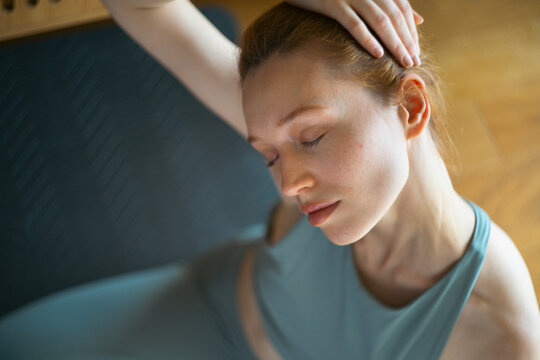 Woman stretching neck, finding physical and mental wellness