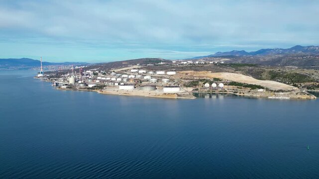 Aerial view of the INA Rijeka Refinery in Urinj, Croatia, on the Adriatic coast. Industrial complex with storage tanks by the sea.