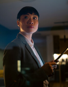 Asian businesswoman using tablet working late at night