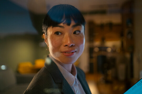 Asian businesswoman looking confident working in office evening light