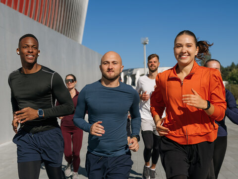 A group of people running in the city