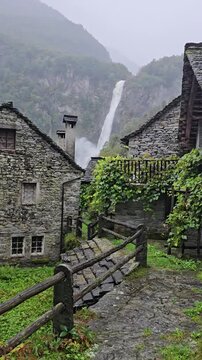 Dramatic view of the thundering Foroglio Waterfall, Cascata di Foroglio, crashing down a cliff in Val Bavona, Ticino, Switzerland, ideal for nature travel guides.