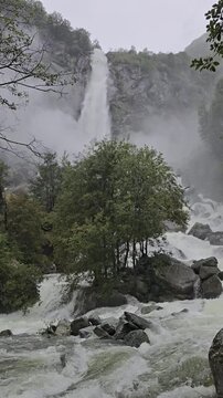 Dramatic view of the thundering Foroglio Waterfall, Cascata di Foroglio, crashing down a cliff in Val Bavona, Ticino, Switzerland, ideal for nature travel guides.