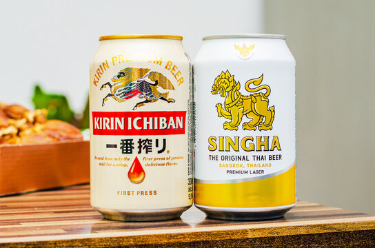 ISERLOHN, GERMANY &mdash; FEBRUARY 23, 2026: cans of Kirin Ichiban and Singha premium beers on wooden surface