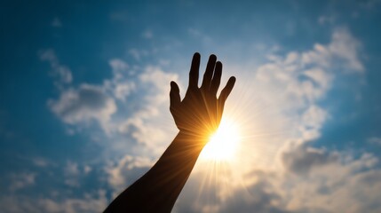 Silhouette of hand reaching towards sunlight with bright sky and clouds