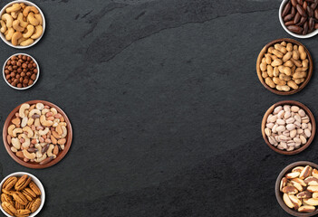 Assorted nuts over stone background with copy space