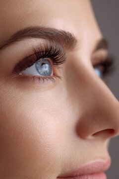 Close-up of young caucasian female eye with blue iris and long eyelashes