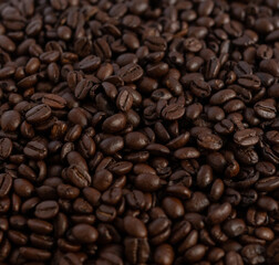 Fototapeta premium Roasted coffee beans macro texture background, full frame top view.