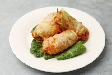 Yummy stuffed cabbage rolls on grey table, closeup
