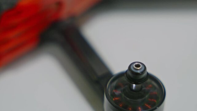 Close-up of drone brushless motor spinning without propeller attached. Exposed rotor motion, electronic activation and propulsion system test. High quality 4k footage