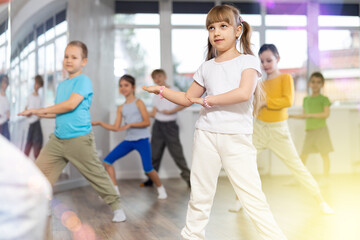 Group of children boys and girls dance modern dance in studio