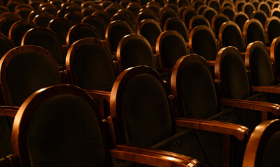 Empty Classic Theater Auditorium with Rows of Velvet Seats and Wooden Armrests